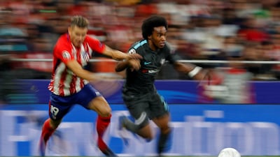 Chelsea's Willian dribbles past Atletico Madrid's Lucas Hernandez. Paul Hanna / Reuters