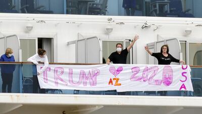 Passengers display a banner reading 'Trump 2020' on the deck of the cruise ship Diamond Princess. Kyodo / via Reuters