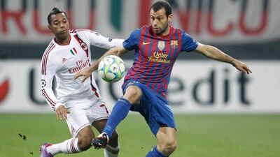 Barcelona's Javier Mascherano is put under pressure by AC Milan's Robinho during the goalless draw between the two sides.