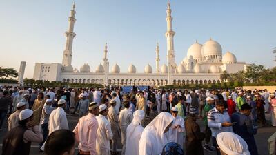 Worshippers celebrate Eid Al Fitr outside Sheikh Zayed Mosque early on Tuesday morning.