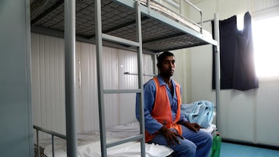 A worker sits in his room during his mid-shift break. Christopher Pike / The National