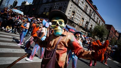 Participants wearing skull masks perform during the annual Day of the Dead parade in Mexico City. Reuters