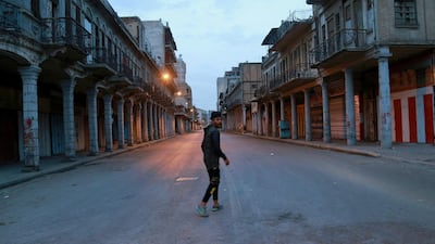 A man walks down an empty street in central Baghdad, Iraq. AP Photo