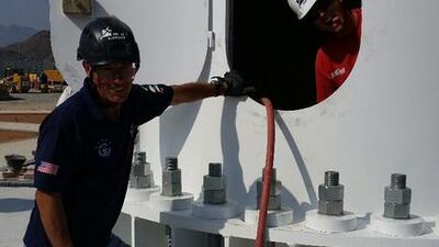 The Trident Support team work on erecting the two new flagpoles in Fujairah and Umm Al Quwain.