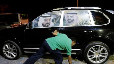 Sedra Car Decoration in Al Shahama was busy applying photos of UAE leaders to cars for National Day yesterday. Christopher Pike / The National