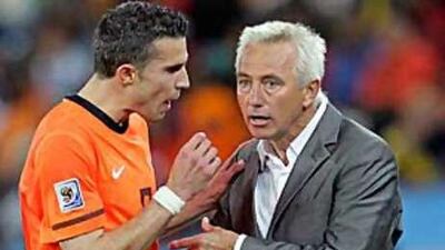 Bert van Marwijk, right, the Holland coach, tries to calm Robin van Persie down after the Dutch striker was substituted against Slovakia.