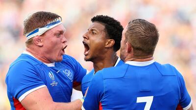 Chad Plato, centre, of Namibia celebrates scoring his side's third try against Italy. Getty Images