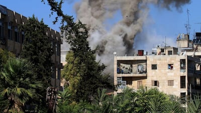 Smoke rises from buildings in an eastern government-held neighbourhood of Aleppo following reported opposition fire on October 20, 2016. George Ourfalian/AFP