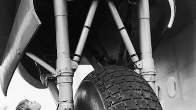 A young visitor stands by the wheel of an Avro York transport plane at Farnborough Airshow in 1950.