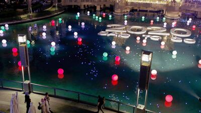 Celebrations underway at the Dubai Mall Fountain where members of the public could register and write their wish on an LED ball which was then set afloat in the fountain. Antonie Robertson/ The National