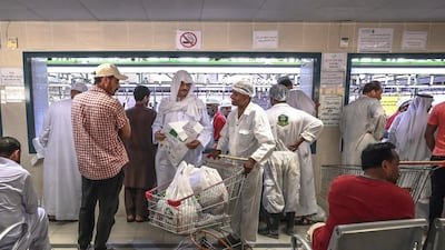 Customers wait for their meat to be delivered.
