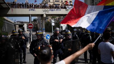Protesters face French riot police during a demonstration in Marseille, southern France. Thousands of people marched in dozens of cities across France for a fifth straight Saturday to denounce a Covid-19 health pass needed to enter restaurants, trains and other venues.