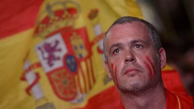A Spain fan reacts during the team's loss to Chile on Wednesday night at the 2014 World Cup in Brazil while watching on a screen in Madrid. Dani Pozo / AFP / June 18, 2014