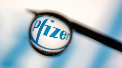 Pfizer logo is reflected in a drop on a syringe needle in this illustration photo taken March 16, 2021. Picture taken March 16, 2021. Reuters
