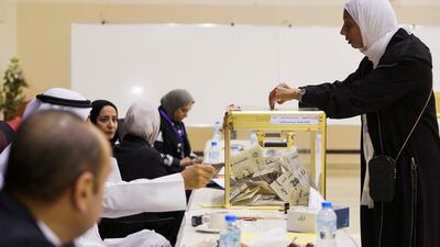A woman votes during parliamentary elections at a polling station in Kuwait City. Reuters