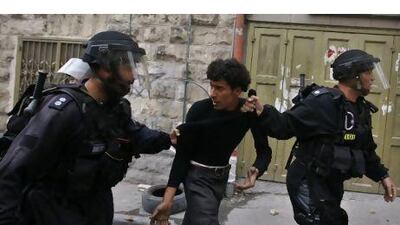 Israeli riot policemen arrest a Palestinian man during clashes in the east Jerusalem Arab neighborhood of Issawiya yesterday amid protests marking the 63rd anniversary of Israel's creation, called 'Nakba' or 'Catastrophe' by the Palestinians.