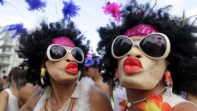 Mask-wearing revellers pose for a photo during the Banda de Ipanema Carnival parade in Rio. Silvia Izquierdo / AP Photo