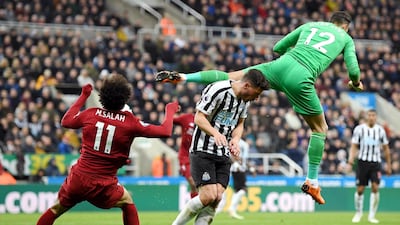 Mohamed Salah of Liverpool picks up an injury as he collides with Martin Dubravka of Newcastle United as they compete for the ball. Shaun Botterill / Getty Images