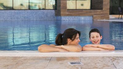 Sema Faulkner with her inspirational nine-year old son Oliver, who will take part in the aquathlon. Mona Al Marzooqi / The National