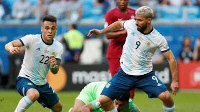 Argentina's Lautaro Martinez and Sergio Aguero in action with Qatar's Saad Alsheeb. Reuters