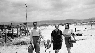 A family going for a stroll along the sea at a Jewish settlement in Palestine, in June 1946. Two years later, war broke out between Palestinians and Jewish communities and the state of Israel was founded. Britain’s role in the conflict is still contentious AP Photo