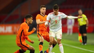 Spain’s Gerard Moreno takes on Netherlands’ Joel Veltman and Owen Wijndal. Reuters