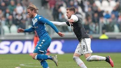 Birkir Bjarnason of Brescia Calcio is challenged by Aaron Ramsey of Juventus. Getty Images
