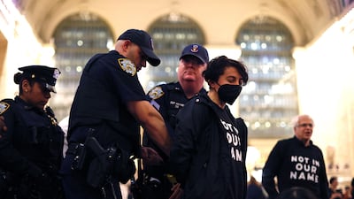 NYPD officers arrest a protester during the demonstration at Grand Central Station in New York City on Friday. AFP