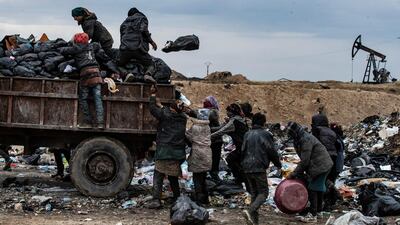 Syrians sift through a garbage dump in the countryside of Malikiya in northeast Syria. AFP