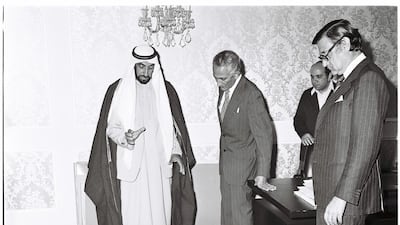 The Founding President, Sheikh Zayed, looks at future Abu Dhabi projects, including a model of Zayed Sports City Stadium visible at bottom. Courtesy: Al Ittihad
