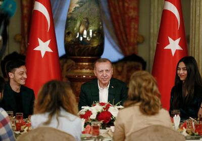 Turkey's President Recep Tayyip Erdogan, centre, is flanked by Turkish-German football star Mesut Ozil and his wife Amine Gulse during an Iftar dinner AP