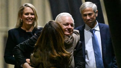 Mr Assange hugs his wife Stella Assange after arriving in Canberra. AFP