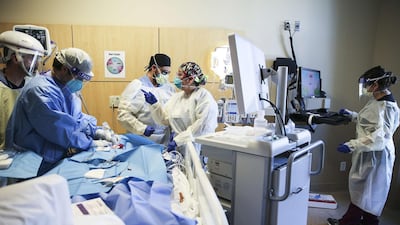 Healthcare workers treat a patient in a Covid-19 intensive care unit at a hospital in Los Angeles, California. Minority groups, such as Arab Americans, have been hit hard by the pandemic. Getty Images/AFP