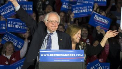 Democratic presidential candidate, Senator Bernie Sanders, and his wife Jane acknowledge the crowd as he arrives for his caucus night rally in Des Moines, Iowa on Monday. Patrick Semansky / AP