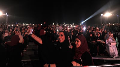Saudi women take a selfie as they attend a concert by Egyptian pop sensation Tamer Hosny. Amer Hilabi / AFP