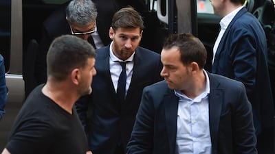 Barcelona football star Lionel Messi, centre, arrives at the courthouse on June 2, 2016 in Barcelona, where Messi and his father are to face judges in a tax fraud case. .Josep Lago / AFP
