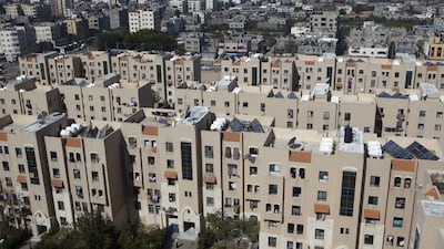 An overview showing part of Sheikh Zayed City against the skyline of the densely populated Gaza Strip which has a chronic housing shortage. Sheikh Zayed City was intended to be much bigger but further construction came to a halt after Hamas took over the territory in 2007 and Israel enforced a blockade. Heidi Levine for The National