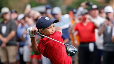 Charlie Woods hits his tee shot on the 1st hole. Reuters