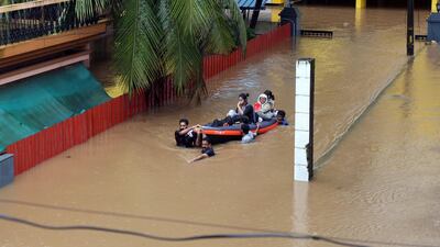 Rescue workers evacuate people from flooded areas on the outskirts of Kochi. Reuters