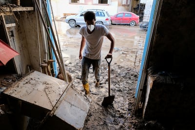 A man clears mud from his pharmacy, which was affected by the fatal floods in Derna, Libya. Reuters
