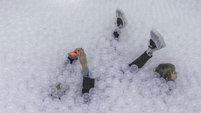 A woman takes a selfie in a pool of plastic balls at the Blow Up Experience installation, part of an exhibition of inflatable art and technology, in Montevideo, Uruguay. AP Photo
