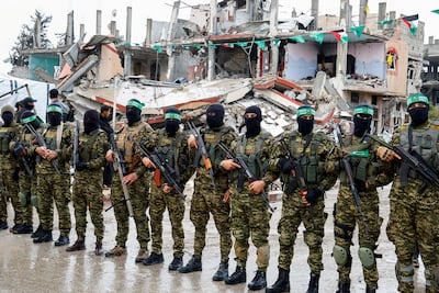 Hamas militants guard the site for a handover of hostages in Rafah, southern Gaza, in February, as part of a ceasefire deal with Israel that collapsed the following month. Reuters