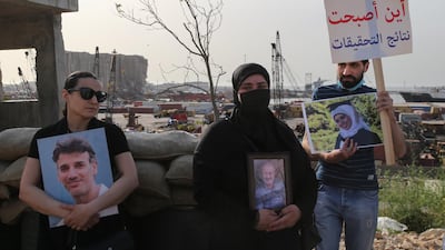 Families of the August 4 Beirut blast victims carry portraits of the deceased relatives as they stage a protest in the Lebanese capital. EPA