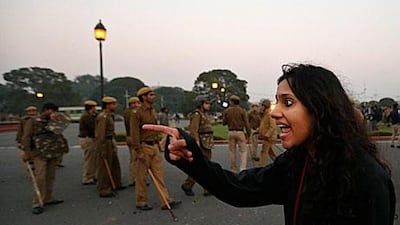 A protester points at police at a demonstration in New Delhi yesterday. Indian police have banned protests and marches against the violent gang-rape of a woman on a bus last week.