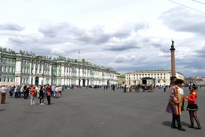 People walk outside the Hermitage Museum in Saint Petersburg, Russia. AFP
