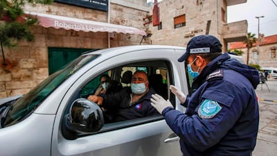 Palestinian security forces stop a vehicle at a checkpoint in Beit Jala on the outskirts of Bethlehem. AFP