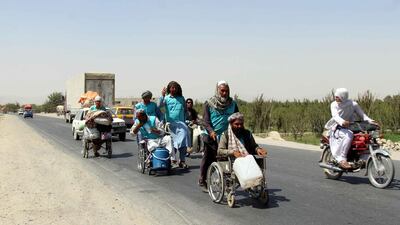 Afghan people, some in wheelchairs, reach Kandahar province on a journey by foot from Herat province to Kabul to cover a distance of about 1,800km, calling an end to decades old war, in Kandahar, Afghanistan. EPA