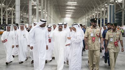 Sheikh Ahmed Al Maktoum, centre, chairman and chief executive of Emirates Airline and Group, inaugurated the new cargo terminal. He was given a tour by Nabil Sultan, left, Emirates Divisional senior vice president, Cargo. Reem Mohammed / The National