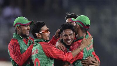 Bangladesh cricketers congratulate teammate Mustafizur Rahman after he took five wickets on his one-day international debut on Thursday night. Munir uz Zaman / AFP