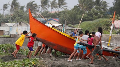 Filipino fishermen secure a boat in the town of Aparri, Cagayan province, Philippines. Francis R. Malasig / EPA